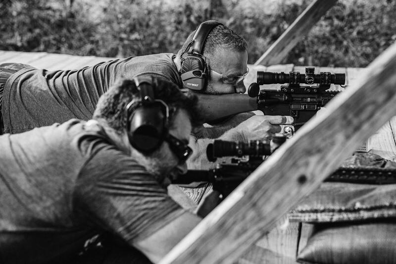 Two Ballistic team members sighting in rifles on the firing line