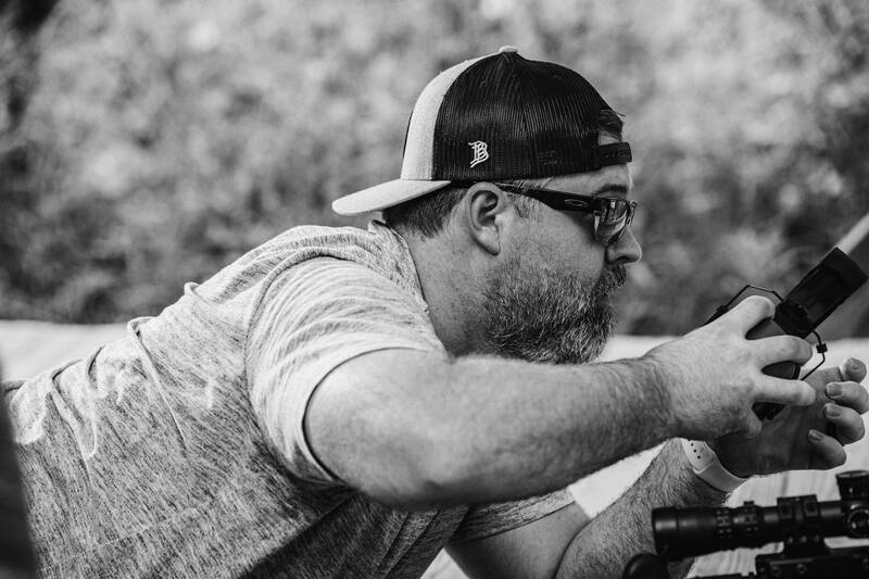 Ballistic team member adjusting a rifle at the range